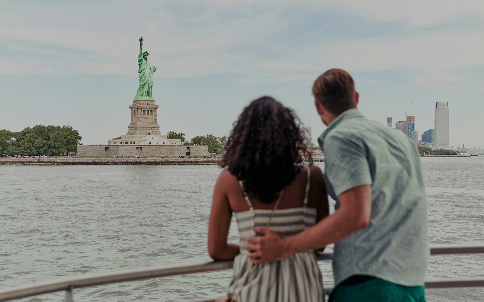 New York City skyline at sunset during a harbor lights cruise.