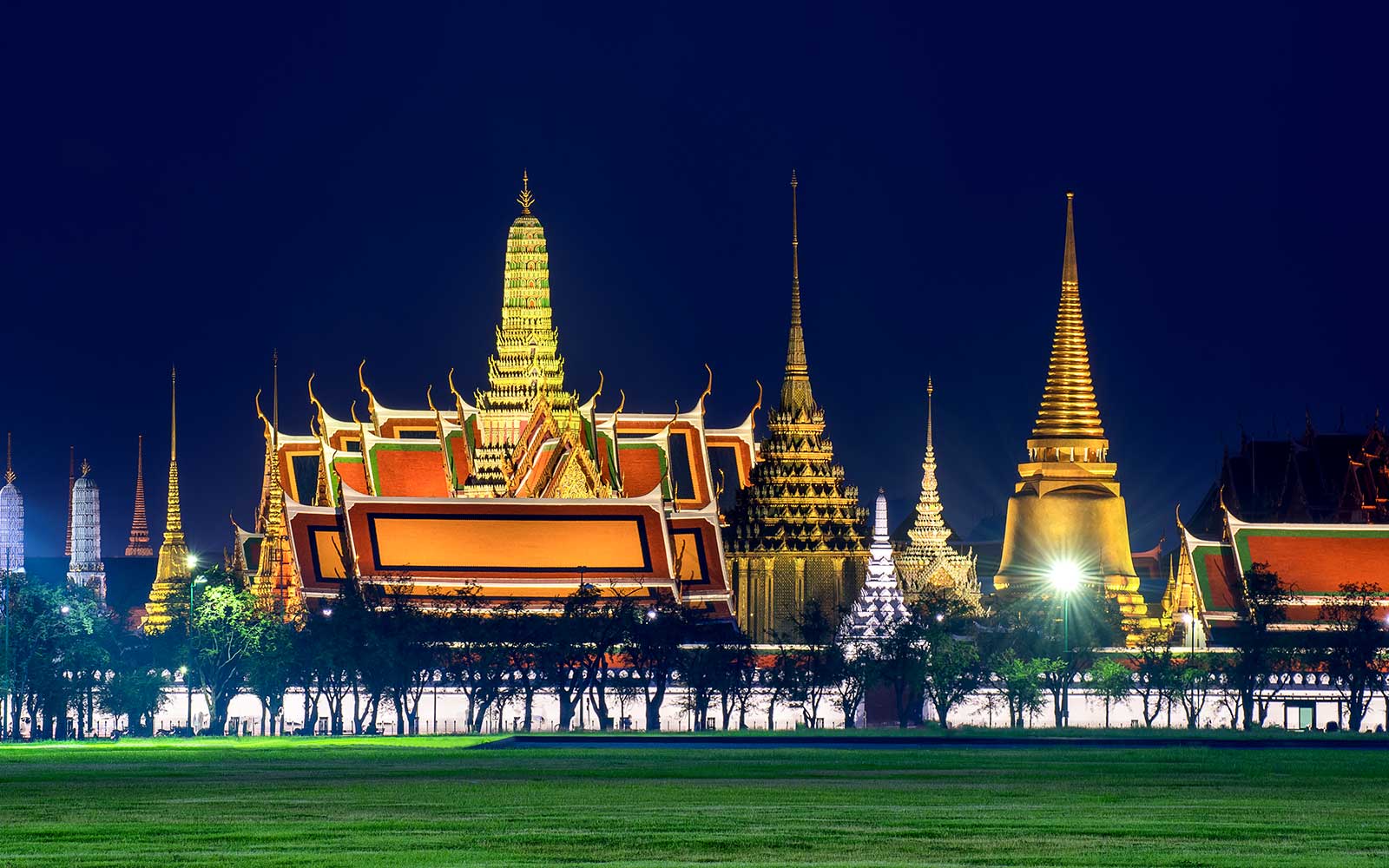 Grand Palace illuminated at night during Bangkok Night Bike Tour.