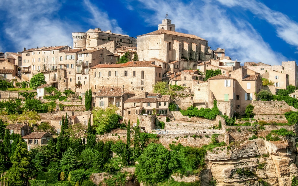 Hilltop village in Provence with stone buildings and lush greenery, part of Lavender Full Day Tour.