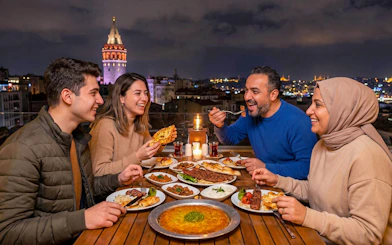 Group enjoying traditional Turkish dishes on a rooftop with Galata Tower view in Istanbul.