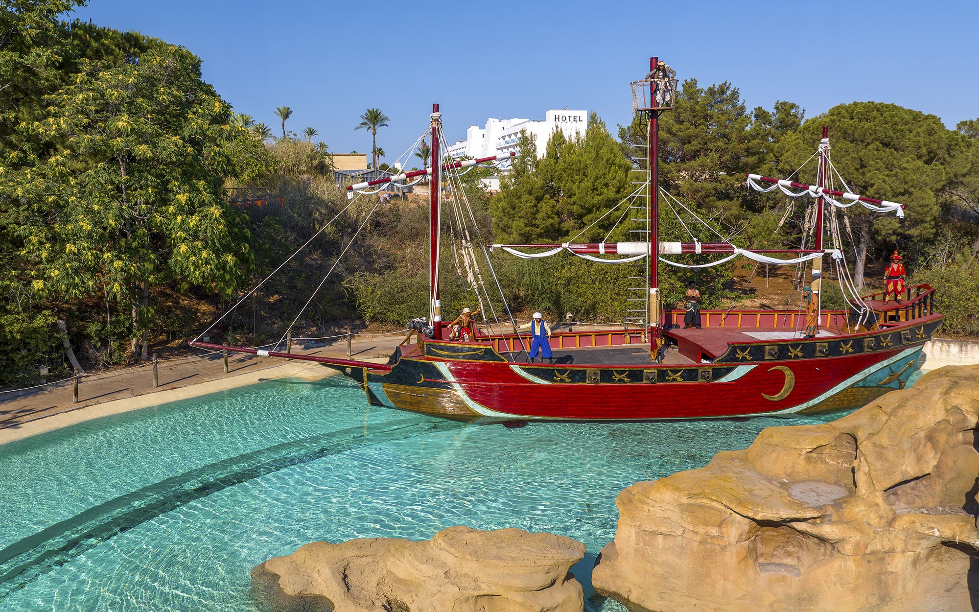 Pirate ship attraction at Terra Mitica Benidorm with surrounding greenery.