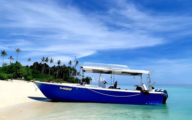 Boat on Mataking Island beach, Semporna, for snorkeling day tour.