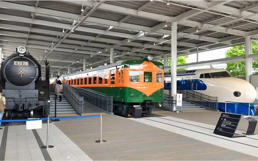 Historic trains and a Shinkansen exhibit at Kyoto Railway Museum.