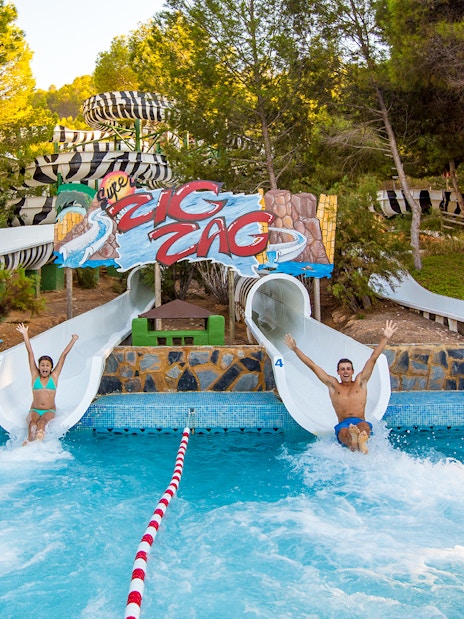 People sliding down water slides at Aqualand Costa Adeje, Tenerife.