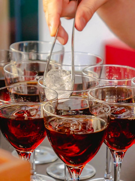 Glasses of red wine with ice being prepared for Tipsy Tour in Rome.