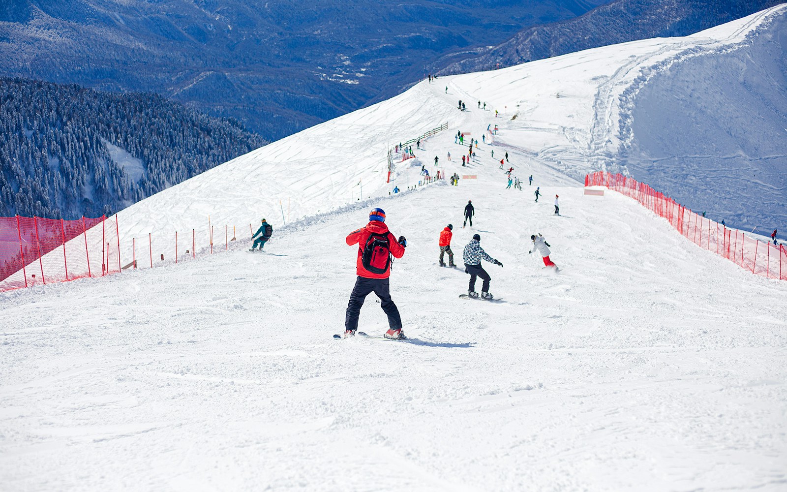 Skiers and snowboarders on a snowy slope in Arachova Village, Greece.