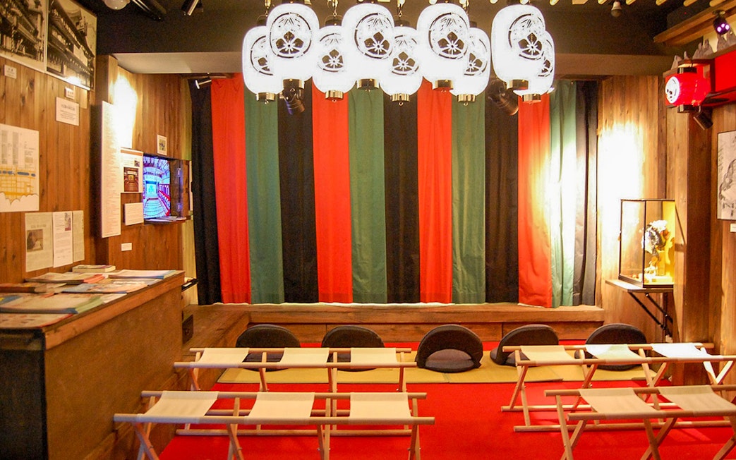 Seating area inside Osaka Dotonbori Museum Namikiza with traditional decor.