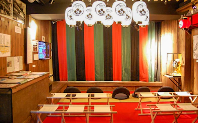 Seating area inside Osaka Dotonbori Museum Namikiza with traditional decor.