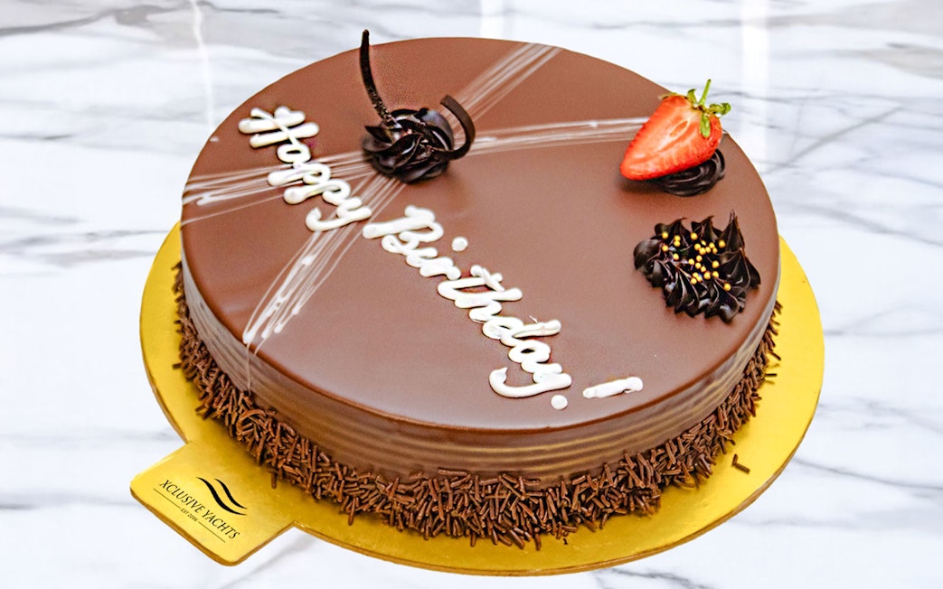 Chocolate cake with "Happy Birthday" on luxury yacht, Dubai.