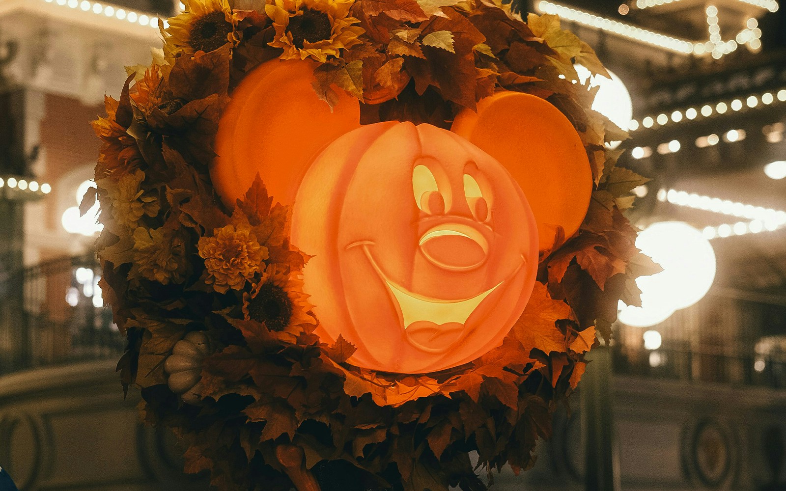 Disney Halloween decoration featuring a Mickey Mouse pumpkin surrounded by autumn leaves.