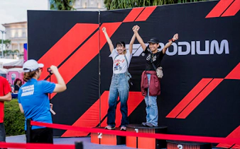 Tourists posing on a podium at Formula 1 Singapore Grand Prix photo op.