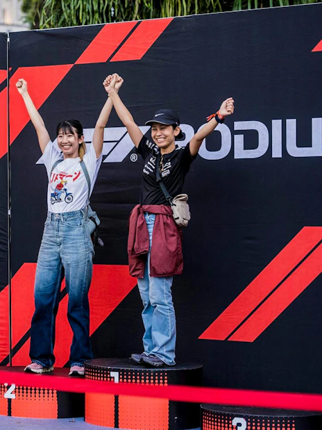 Tourists posing on a podium at Formula 1 Singapore Grand Prix photo op.