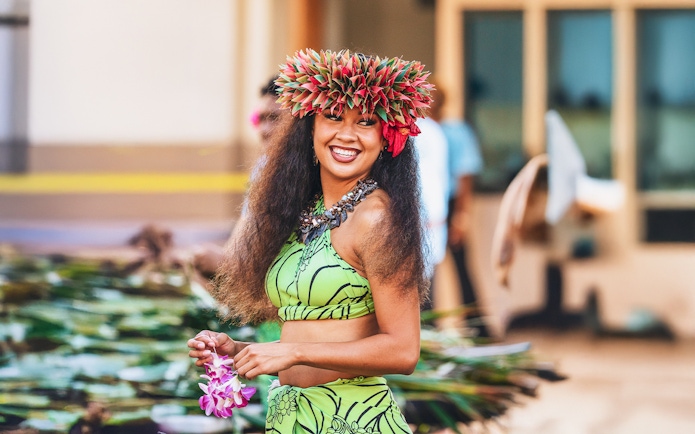 Performer in traditional attire at Moana Luau, Hawaii.