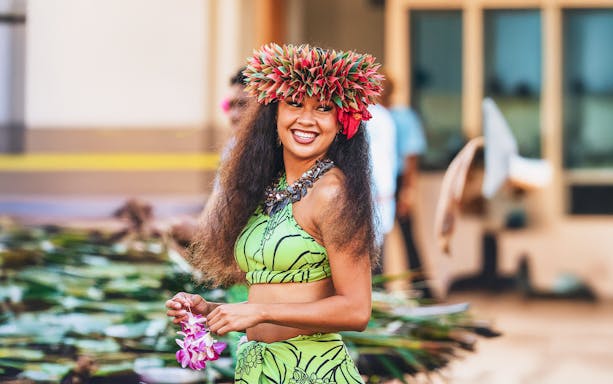 Performer in traditional attire at Moana Luau, Hawaii.