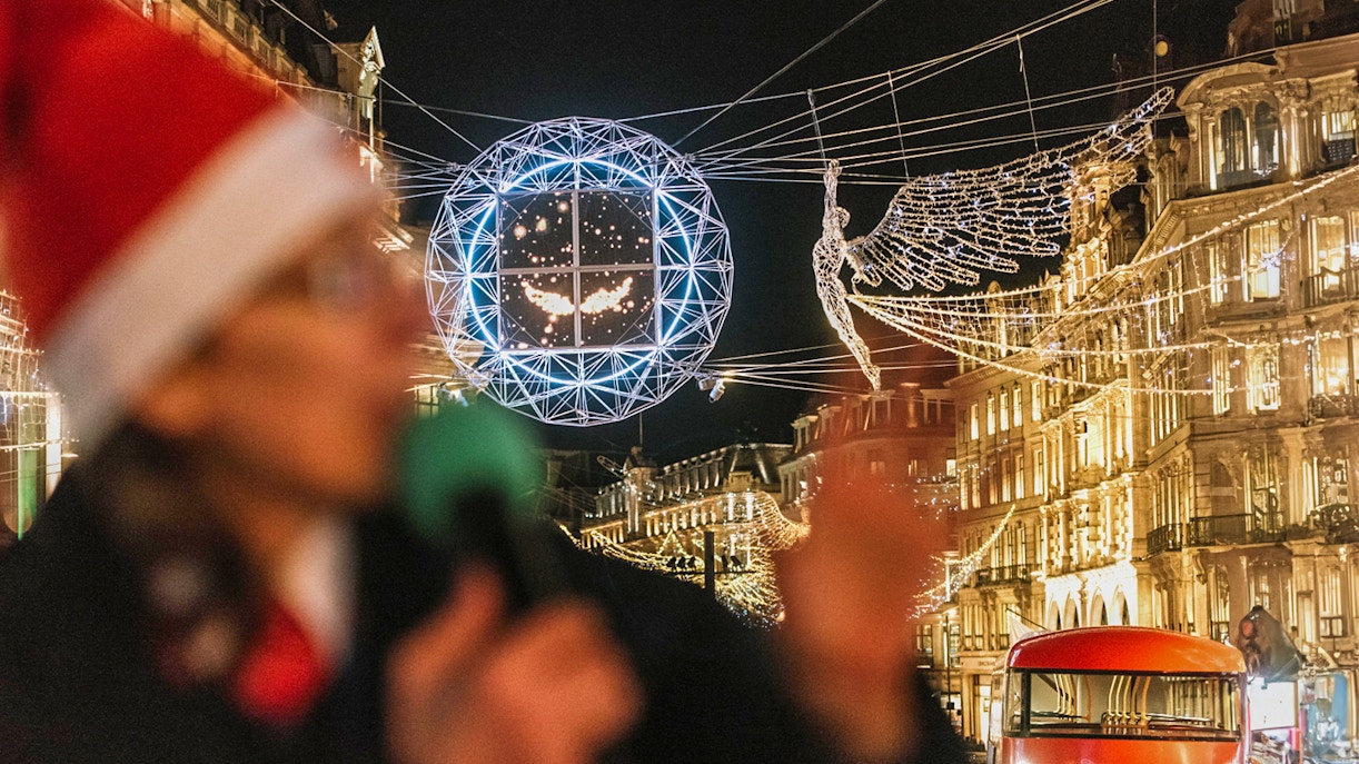 London Christmas lights and red bus on Tootbus tour at night.