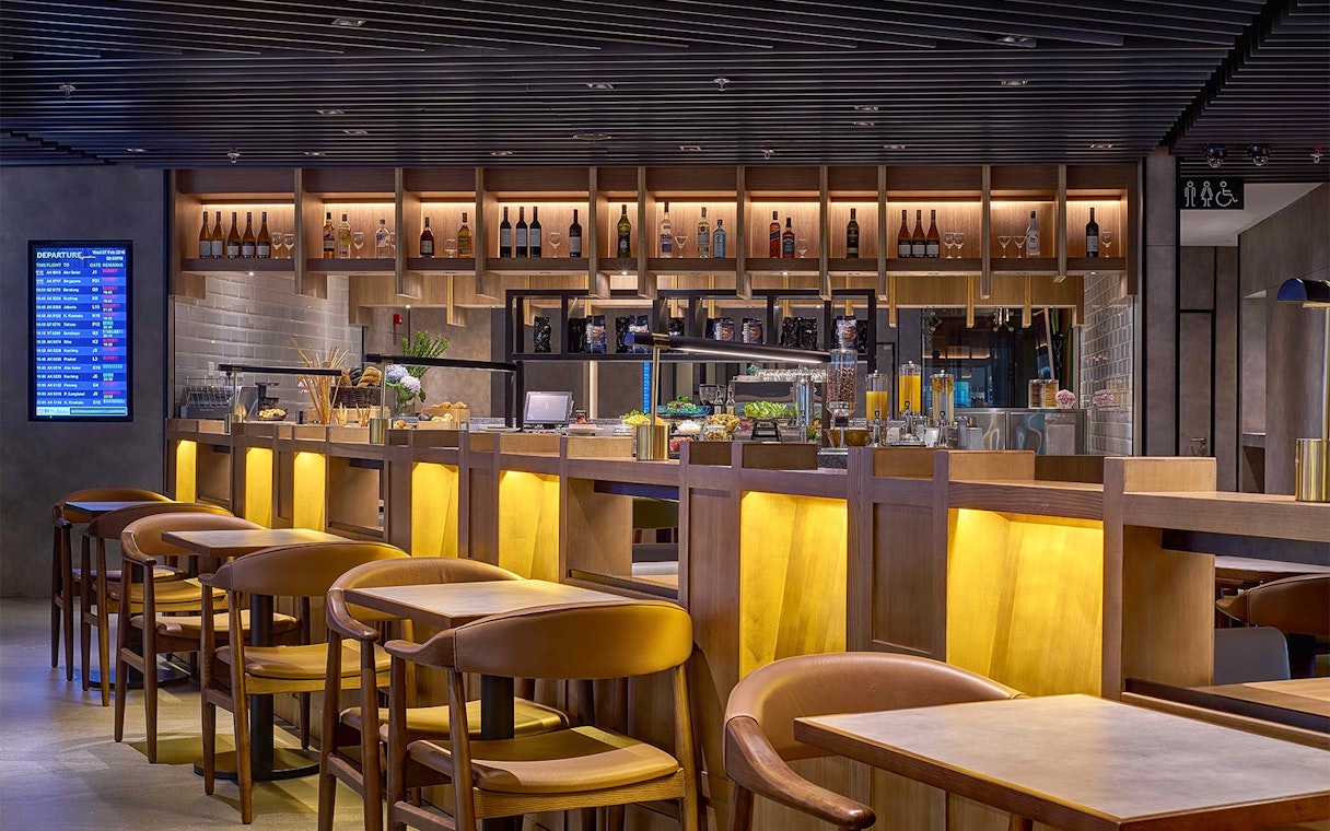 Plaza Premium Lounge seating and bar area at Kuala Lumpur International Airport.