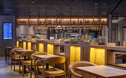 Plaza Premium Lounge seating and bar area at Kuala Lumpur International Airport.