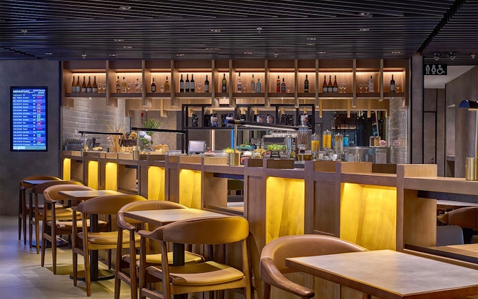 Plaza Premium Lounge seating and bar area at Kuala Lumpur International Airport.