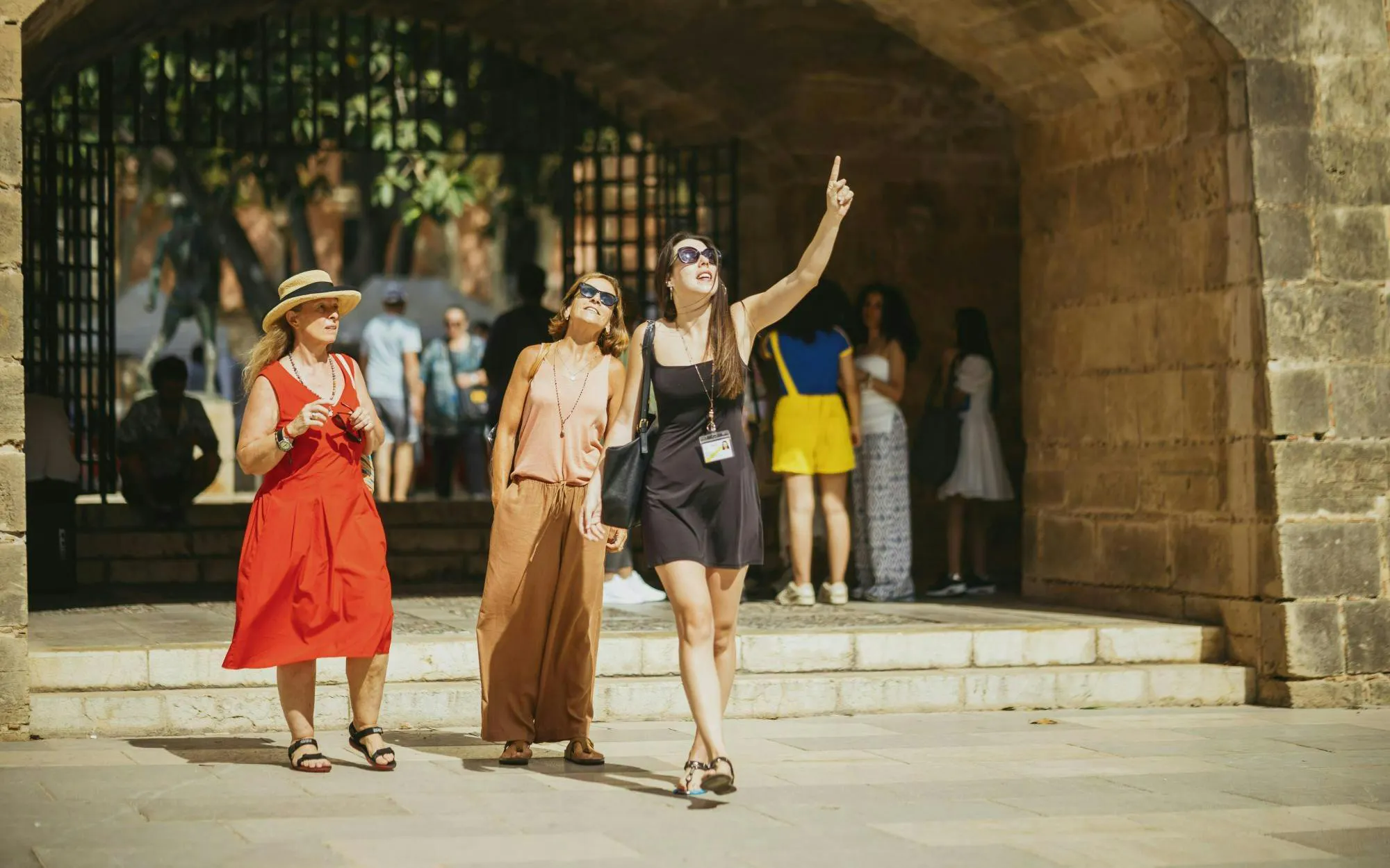 Tourist group with guide exploring historic site in Palma de Mallorca.