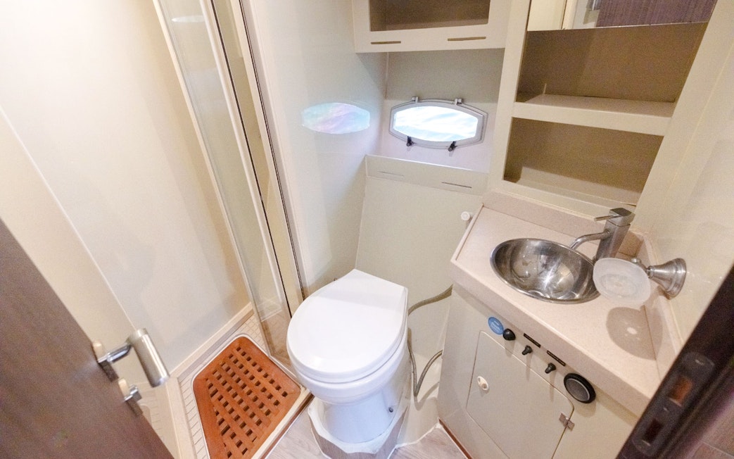 Luxury yacht bathroom with toilet, sink, and shower on Viktoriia Yacht.