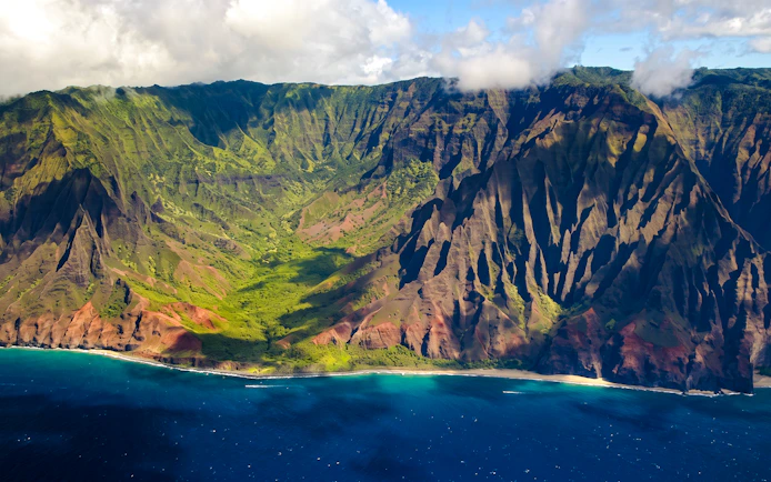 Aerial view of Na Pali Coast cliffs and ocean on Kauai, Hawaii.