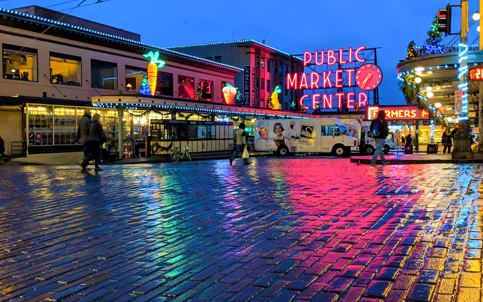 Seattle's Pike Place Market bustling with visitors and vendors displaying fresh produce and local goods.