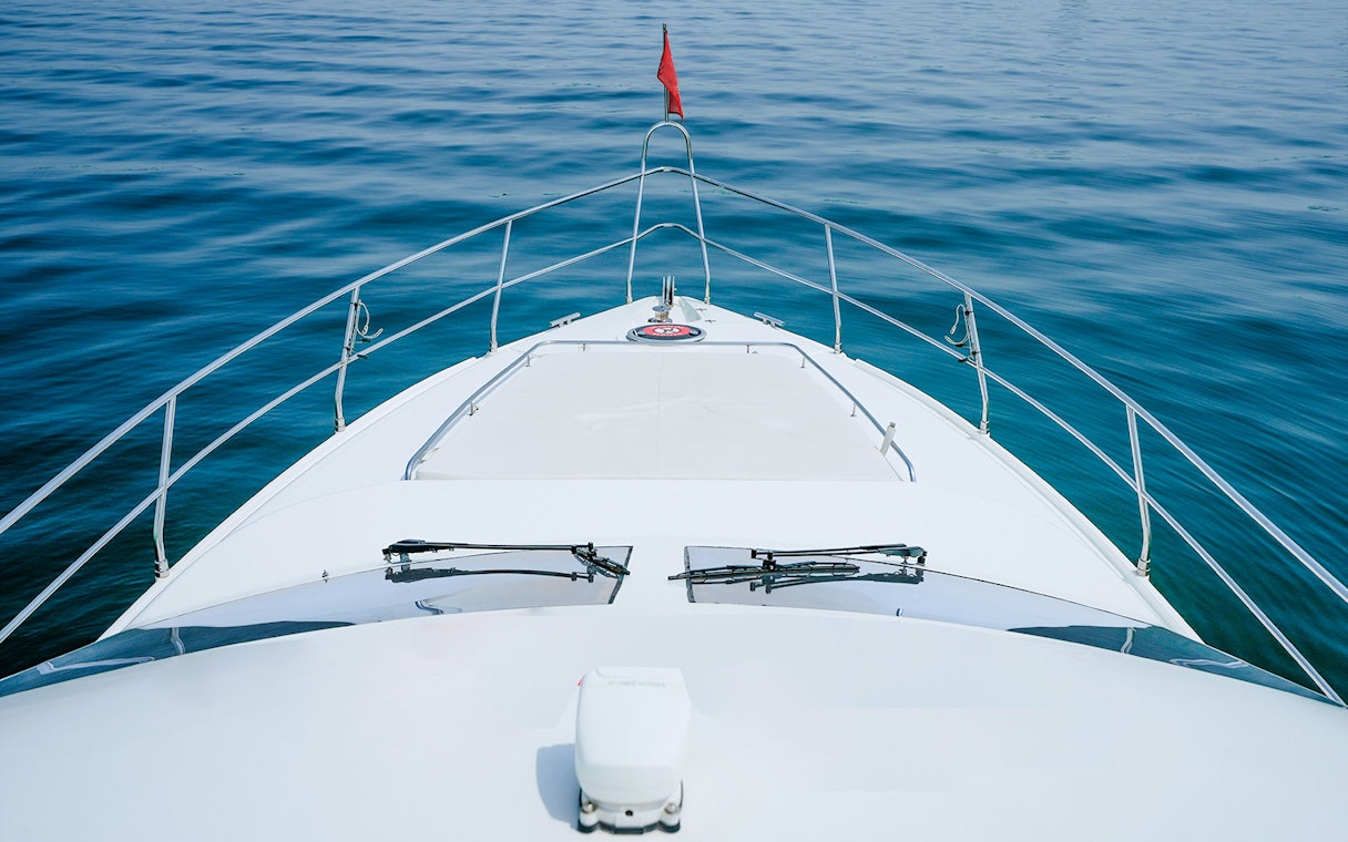 Luxury yacht bow on calm sea, Dubai.