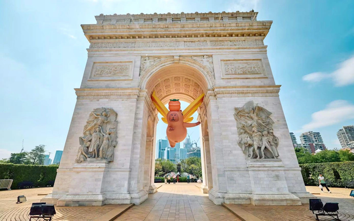Replica of Arc de Triomphe with inflatable character at Window of the World, Shenzhen, China.