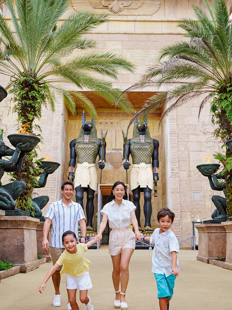 Family with toddlers at Egypt Zone, Universal Studios Singapore, surrounded by Anubis statues.
