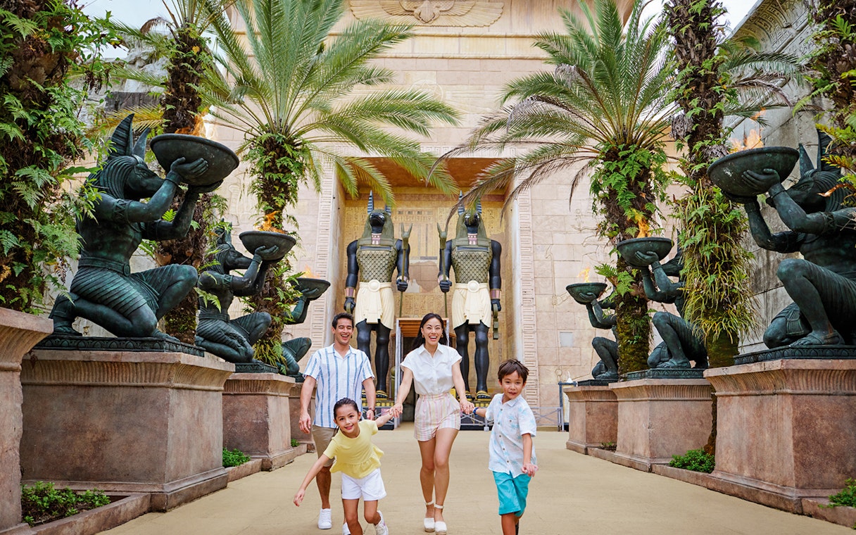 Family with toddlers at Egypt Zone, Universal Studios Singapore, surrounded by Anubis statues.