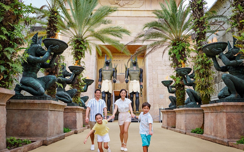 Family with toddlers at Egypt Zone, Universal Studios Singapore, surrounded by Anubis statues.