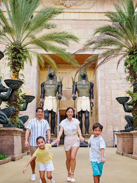 Family with toddlers at Egypt Zone, Universal Studios Singapore, surrounded by Anubis statues.