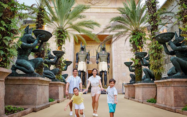 Family with toddlers at Egypt Zone, Universal Studios Singapore, surrounded by Anubis statues.