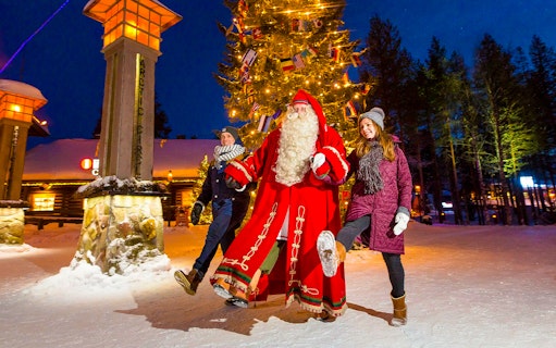 Children with Santa Claus at Santa Claus Village, Rovaniemi, Finland.