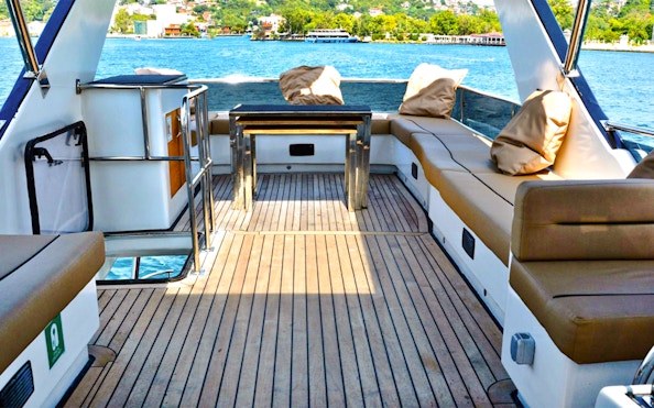 Seating area on luxury private yacht with view of Istanbul waterway.