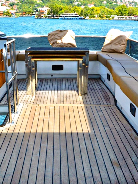 Seating area on luxury private yacht with view of Istanbul waterway.