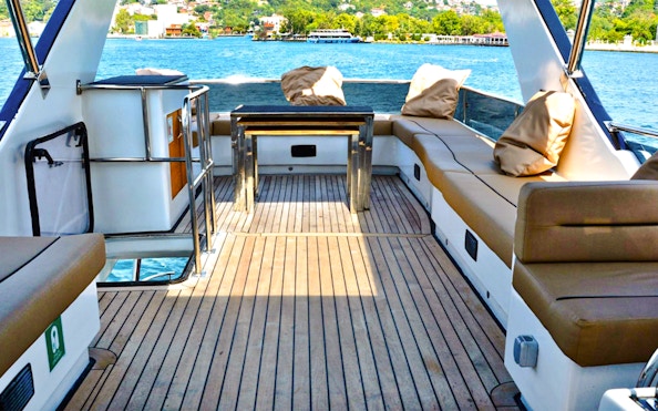 Seating area on luxury private yacht with view of Istanbul waterway.