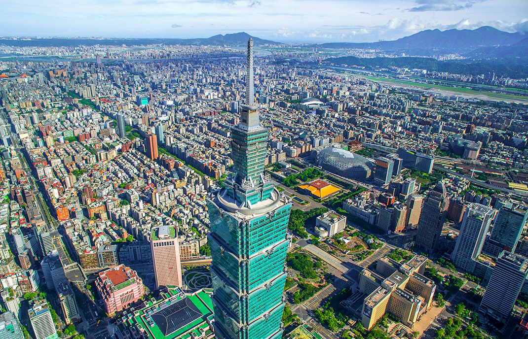 Aerial view of Taipei 101 skyscraper in Taiwan with cityscape in the background.
