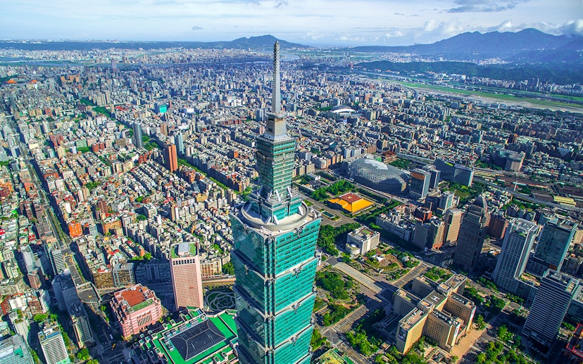 Aerial view of Taipei 101 skyscraper in Taiwan with cityscape in the background.