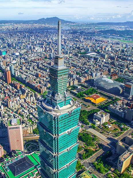 Aerial view of Taipei 101 skyscraper in Taiwan with cityscape in the background.