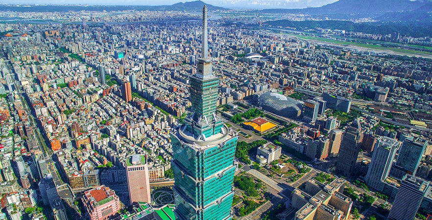 Aerial view of Taipei 101 skyscraper in Taiwan with cityscape in the background.