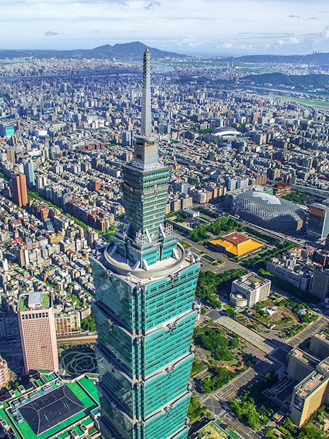 Aerial view of Taipei 101 skyscraper in Taiwan with cityscape in the background.