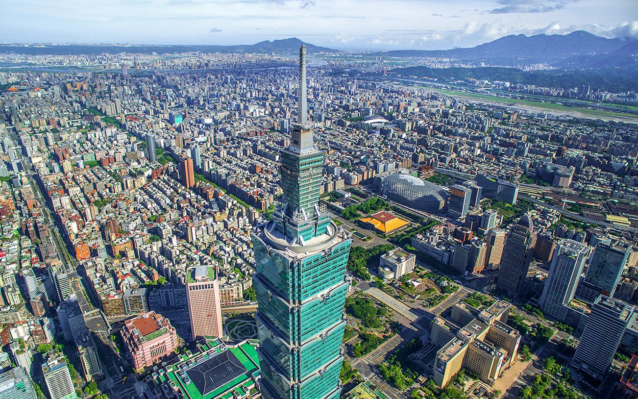 Aerial view of Taipei 101 skyscraper in Taiwan with cityscape in the background.