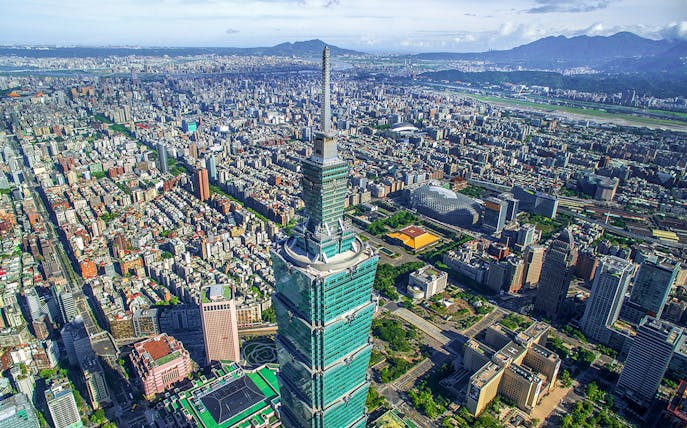 Aerial view of Taipei 101 skyscraper in Taiwan with cityscape in the background.