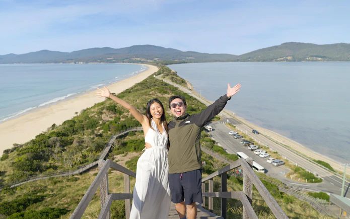 Couple enjoying the view from the Neck Lookout on Bruny Island, Tasmania.