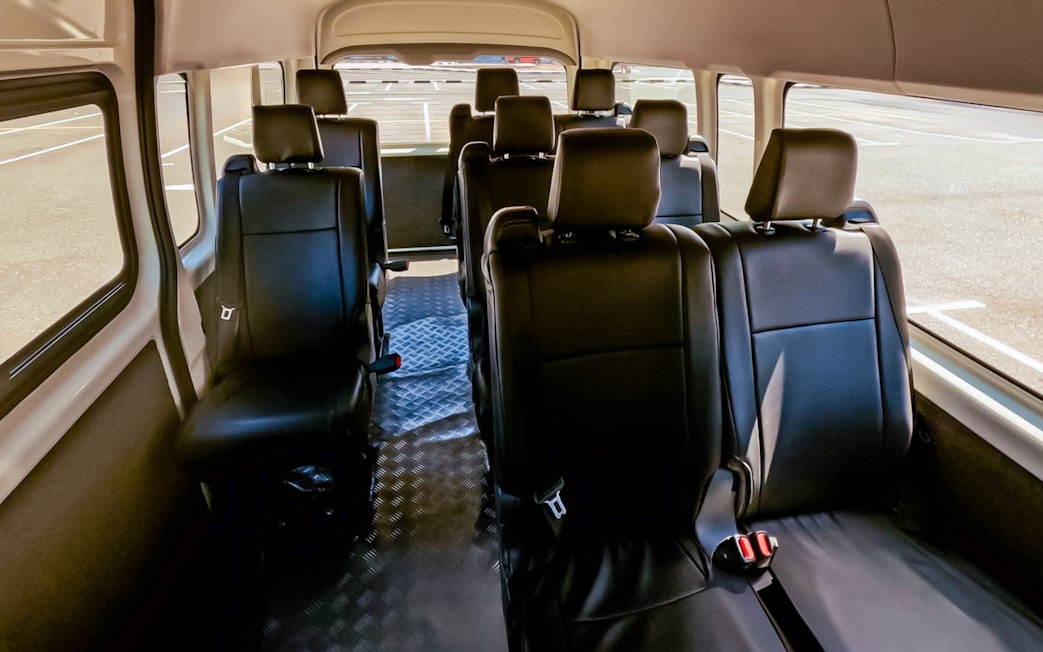 Interior of a shuttle bus for Aquaventure Waterpark transport service.