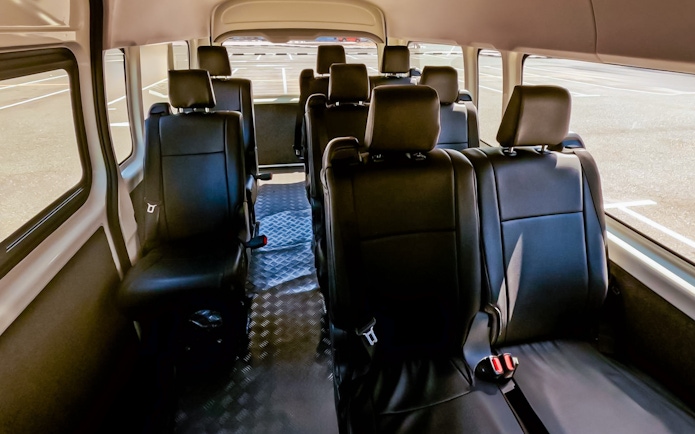 Interior of a shuttle bus for Aquaventure Waterpark transport service.
