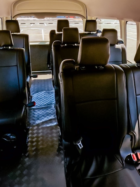 Interior of a shuttle bus for Aquaventure Waterpark transport service.