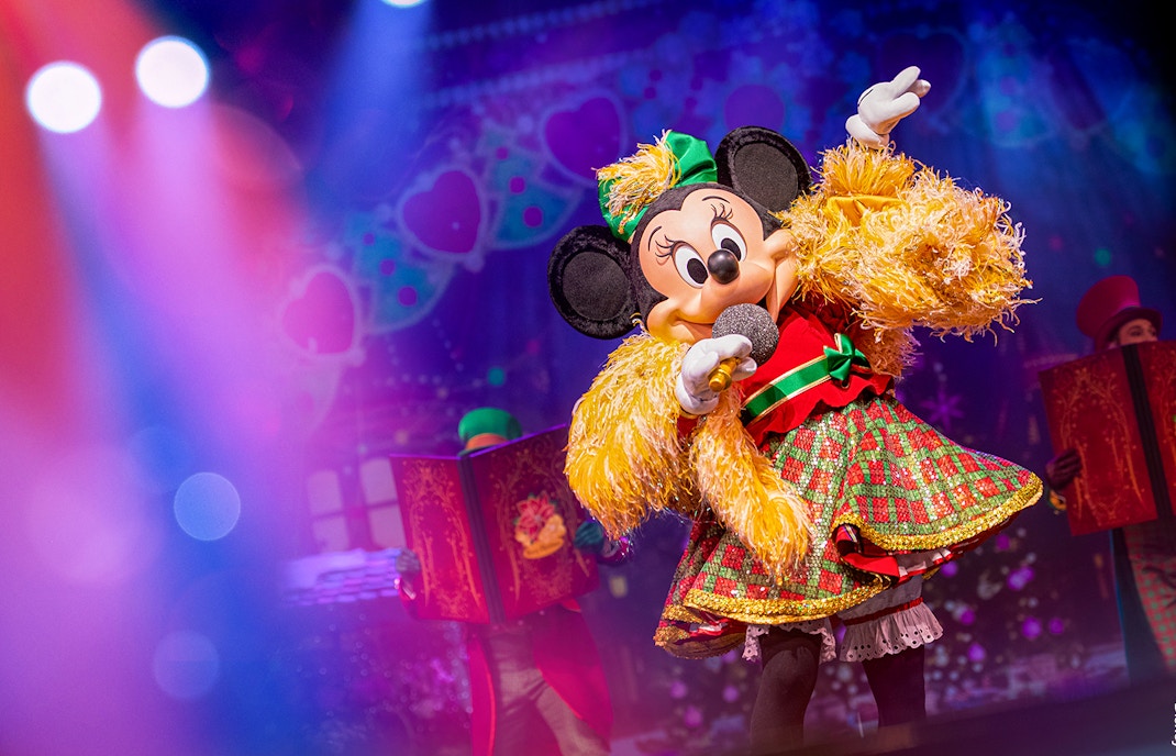 Minnie Mouse performing on stage during Disneyland Paris parade show.