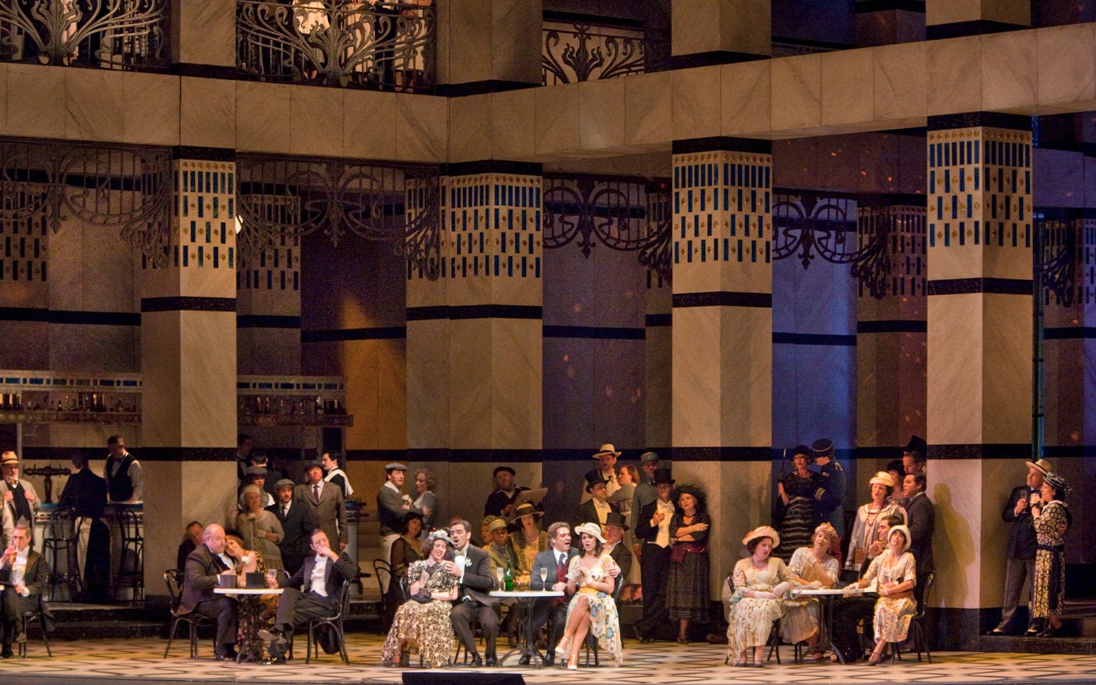 Opera performance of La Rondine with elegantly dressed audience in a grand theater setting.